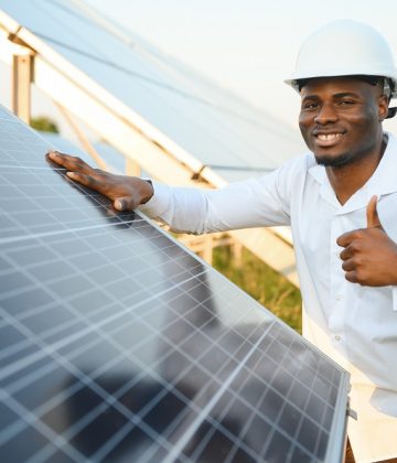African american technician check the maintenance of the solar panels. Black man engineer at solar station